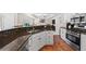 Open kitchen featuring stainless steel appliances, granite countertops, and an inviting breakfast bar at 1803 Gold Finch Way, Lawrenceville, GA 30043