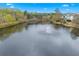 Picturesque view of community lake featuring a fountain, surrounded by mature trees at 1803 Gold Finch Way, Lawrenceville, GA 30043