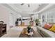 Open-concept living area with direct access to a kitchen featuring stainless steel appliances and bar seating at 1803 Gold Finch Way, Lawrenceville, GA 30043