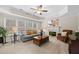 Cozy living room with a fireplace, large windows, and comfortable seating for relaxing and entertaining at 1803 Gold Finch Way, Lawrenceville, GA 30043