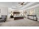 Spacious main bedroom with tray ceiling, sitting area, large windows, and plush carpet, creating a serene retreat at 1803 Gold Finch Way, Lawrenceville, GA 30043