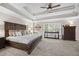 Spacious main bedroom with tray ceiling and decorative furniture at 1803 Gold Finch Way, Lawrenceville, GA 30043