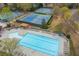 Aerial view showcasing the community pool with lounge chairs and surrounding tennis courts at 1803 Gold Finch Way, Lawrenceville, GA 30043