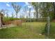 Spacious fenced-in backyard with mature trees, offering privacy and ample room for outdoor activities at 4329 Cedar Valley Ln, Conley, GA 30288