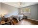 View of a bedroom with wood floors, gray walls, and natural light at 4329 Cedar Valley Ln, Conley, GA 30288