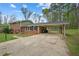 Charming brick home featuring an attached carport, lush landscaping, and a welcoming entrance at 4329 Cedar Valley Ln, Conley, GA 30288
