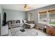 Bright living room showcasing a comfortable couch, large windows, and an inviting atmosphere at 4329 Cedar Valley Ln, Conley, GA 30288