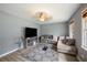 Cozy living room featuring ample natural light, stylish decor, and comfortable seating arrangements at 4329 Cedar Valley Ln, Conley, GA 30288