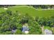 Aerial shot displaying a residence and golf course within a lush wooded setting, offering scenic views at 7350 S Mitchell Ct, Villa Rica, GA 30180