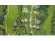 Aerial view of homes situated among the trees bordering a golf course and quiet neighborhood street at 7350 S Mitchell Ct, Villa Rica, GA 30180
