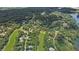 An elevated aerial view of homes nestled among lush trees, adjacent to a scenic golf course and lake at 7350 S Mitchell Ct, Villa Rica, GA 30180