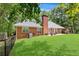 Well-maintained backyard with brick house, patio, and a lush green lawn at 7350 S Mitchell Ct, Villa Rica, GA 30180