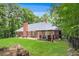 Spacious backyard featuring a brick house, patio, grill, and green lawn at 7350 S Mitchell Ct, Villa Rica, GA 30180