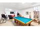 Basement featuring a pool table, TV, seating area, and shelving at 7350 S Mitchell Ct, Villa Rica, GA 30180
