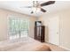 Bedroom with a window, ceiling fan, and a dresser with TV on top at 7350 S Mitchell Ct, Villa Rica, GA 30180
