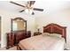 Bedroom with a dresser, mirror, nightstand, ceiling fan, and a window at 7350 S Mitchell Ct, Villa Rica, GA 30180