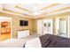 Bedroom with an entertainment center, ceiling fan, and a glimpse of a kitchen at 7350 S Mitchell Ct, Villa Rica, GA 30180