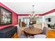 This dining room features hardwood floors, a chandelier, and a view of the living room at 7350 S Mitchell Ct, Villa Rica, GA 30180