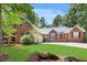 Beautiful brick home with a well-manicured lawn and mature trees in a serene setting at 7350 S Mitchell Ct, Villa Rica, GA 30180