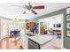 Open kitchen featuring granite countertops, white cabinets, and a view into the cozy living room at 7350 S Mitchell Ct, Villa Rica, GA 30180