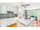 Bright kitchen with white cabinets, granite countertops, stainless steel appliances, and modern backsplash at 7350 S Mitchell Ct, Villa Rica, GA 30180