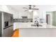 Modern kitchen with stainless steel refrigerator, white cabinets, granite countertops, and stylish backsplash at 7350 S Mitchell Ct, Villa Rica, GA 30180