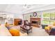 Cozy living room with brick fireplace, desk, and view into the kitchen offers a warm, welcoming atmosphere at 7350 S Mitchell Ct, Villa Rica, GA 30180