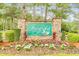 Community entrance sign with stone base and colorful flowers adding charm and curb appeal at 7350 S Mitchell Ct, Villa Rica, GA 30180