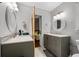 Large bathroom with double vanity sinks, white counters, white marble tile, and modern fixtures at 1131 Hershey Dr, Marietta, GA 30062