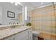 Bright bathroom featuring granite countertops, white cabinets, and a shower with stylish, colorful curtains at 1131 Hershey Dr, Marietta, GA 30062
