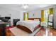 Spacious bedroom features hardwood floors, a ceiling fan, and ample natural light from the windows at 1131 Hershey Dr, Marietta, GA 30062