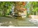Charming home with an attached garage and a well-maintained landscape in a serene, wooded setting at 1131 Hershey Dr, Marietta, GA 30062