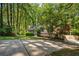 Inviting home featuring a covered front porch and a driveway, surrounded by lush greenery and trees at 1131 Hershey Dr, Marietta, GA 30062