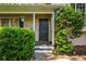 A close-up of a welcoming front door with decorative shrubs at 1131 Hershey Dr, Marietta, GA 30062