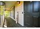 Covered front porch features wood flooring, a welcome sign, and outdoor lighting at 1131 Hershey Dr, Marietta, GA 30062