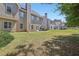 Large grass backyard with a view of the home's exterior, patio, and fencing at 2277 Shady Maple Trl, Loganville, GA 30052