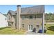 Two-story home with tall chimney, a patio, and spacious backyard grass area at 2277 Shady Maple Trl, Loganville, GA 30052