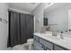 Clean bathroom featuring a vanity with mirror, toilet, and shower with curtain at 2277 Shady Maple Trl, Loganville, GA 30052