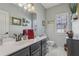 Bright bathroom featuring a large mirror, a window and a vessel sink vanity at 2277 Shady Maple Trl, Loganville, GA 30052