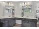 An updated bathroom features double sinks, shaker cabinets and tile floors at 2277 Shady Maple Trl, Loganville, GA 30052