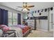 Comfortable bedroom with natural light, ceiling fan, and ample storage space at 2277 Shady Maple Trl, Loganville, GA 30052