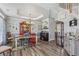 Dining room showcasing modern tray ceiling, colorful decor, wood floors and adjacent staircase at 2277 Shady Maple Trl, Loganville, GA 30052