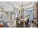 Dining room with wooden table set, front door view and staircase, blending classic charm at 2277 Shady Maple Trl, Loganville, GA 30052