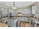 Charming kitchen featuring gray cabinets, stainless steel appliances and granite countertops at 2277 Shady Maple Trl, Loganville, GA 30052