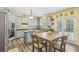 A well-lit kitchen features stainless steel appliances, gray cabinets and a breakfast table at 2277 Shady Maple Trl, Loganville, GA 30052