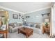 Cozy living room featuring neutral decor, soft carpeting, and plenty of natural light at 2277 Shady Maple Trl, Loganville, GA 30052
