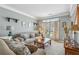 Comfortable living room with neutral walls, plush carpeting, and a large window at 2277 Shady Maple Trl, Loganville, GA 30052