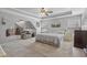 Spacious main bedroom with a ceiling fan, lounge area, and carpet flooring at 2277 Shady Maple Trl, Loganville, GA 30052