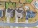 Birds-eye view of residences, showing driveway, rooftop and manicured lawn including planted beds with fresh mulch at 2620 Paddock Point Pl, Dacula, GA 30019