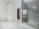 Modern bathroom featuring a glass enclosed shower, tile surround and tile floors at 2620 Paddock Point Pl, Dacula, GA 30019